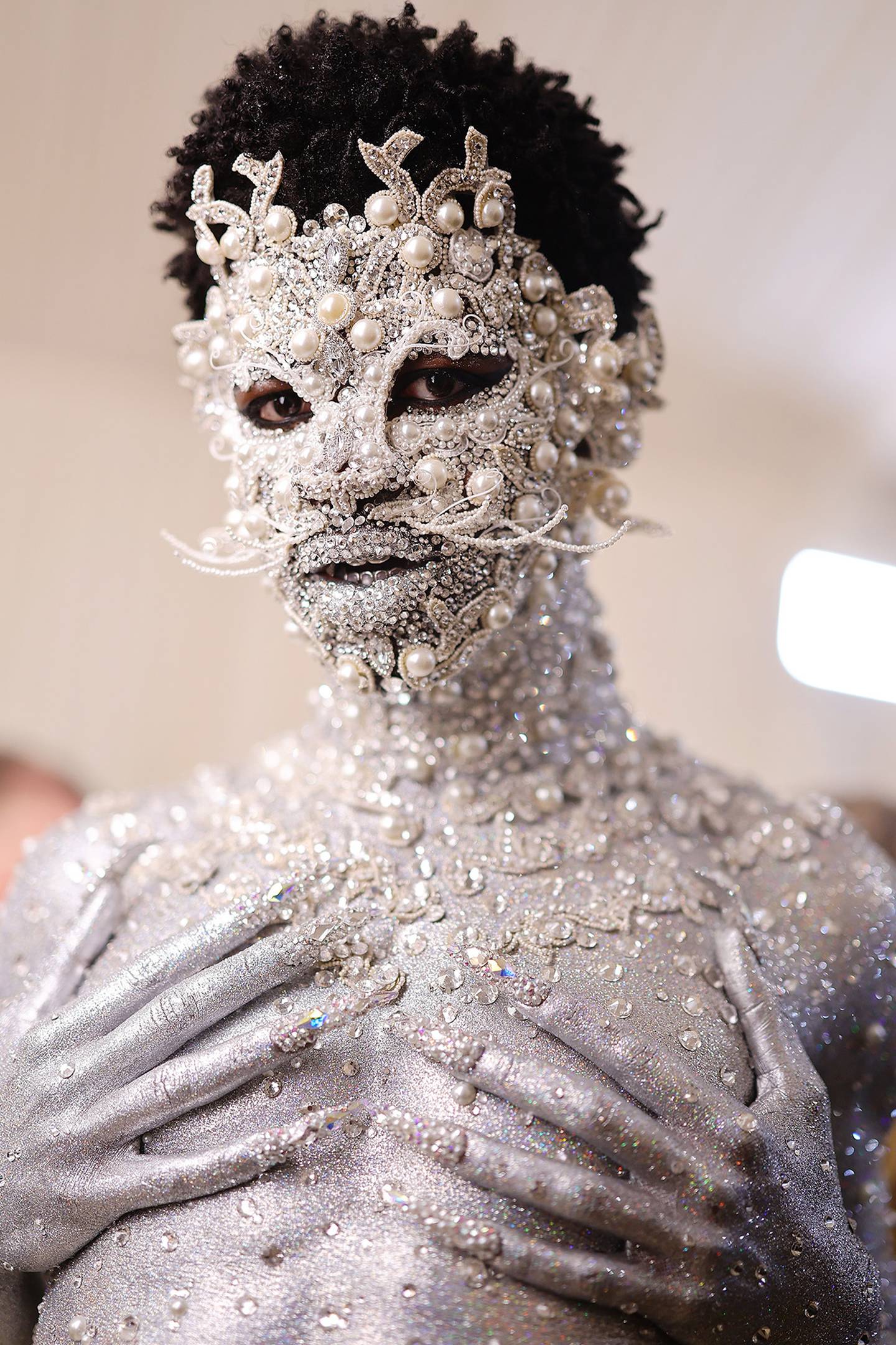 Lil Nas X to the 2023 Met Gala wears a crystal and pearl catsuit by Pat McGrath using Swarovski materials.