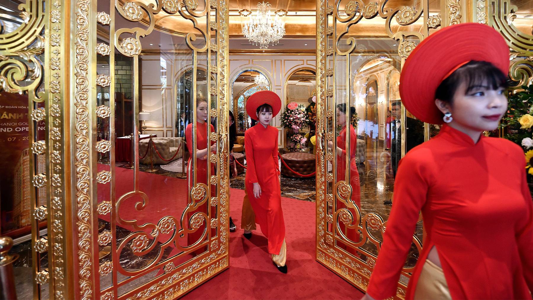 Staff wait to welcome guests in the lobby of the newly-inaugurated Dolce Hanoi Golden Lake hotel, the world's first gold-plated hotel, in Hanoi.