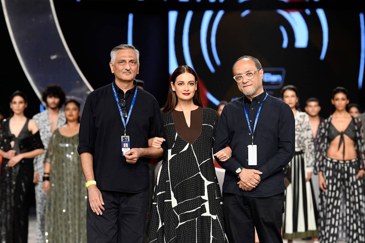 Model Dia Mizra is flanked by Rakesh Thakore (left) and David Abraham (right) during the Abraham & Thakore show at FDCI x Lakmé Fashion Week 2021.