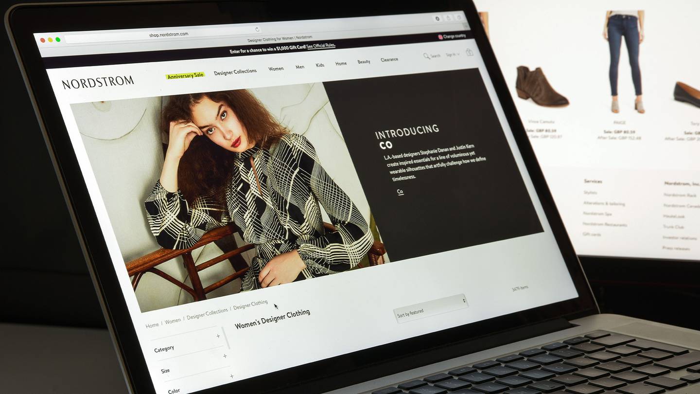 nordstrom ecommerce website model poses laptop computer
