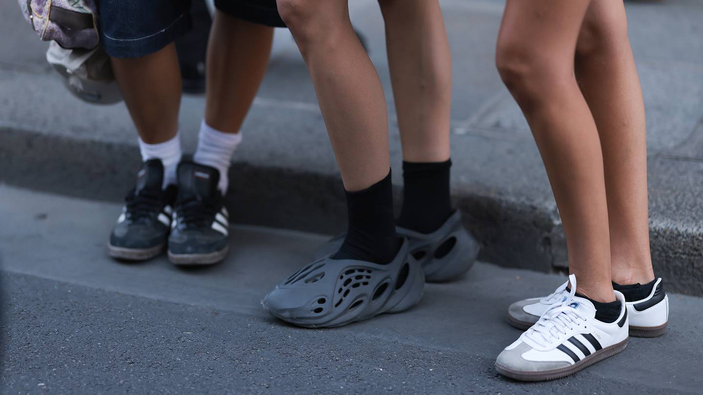 Fashion show guests are seen wearing Adidas shoes, including Yeezy.