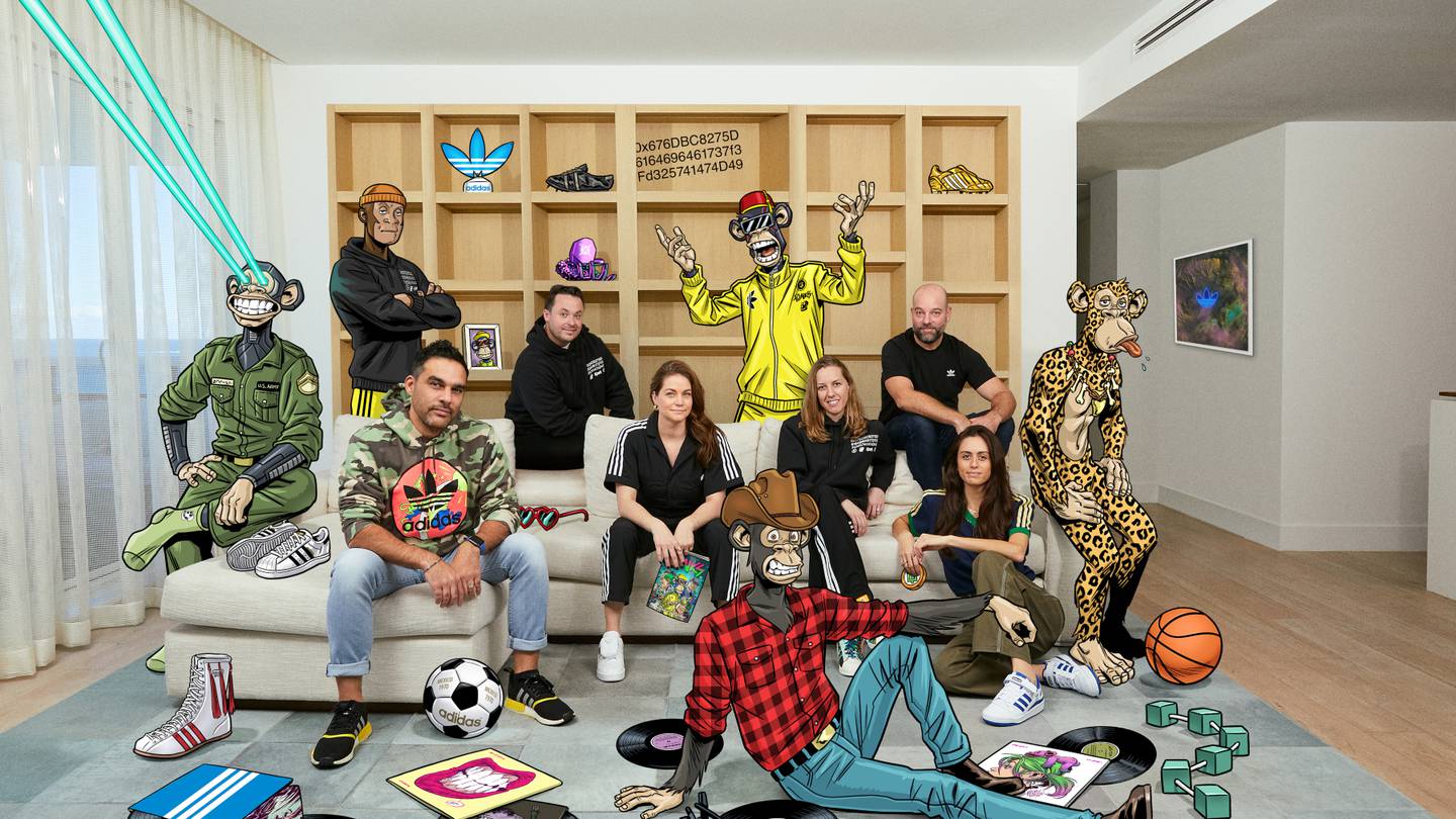 A group of Adidas staff and animated apes sit together in an office.