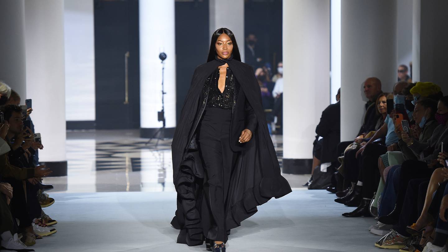 Naomi Campbell strides down the runway in an all black look made up of separates.