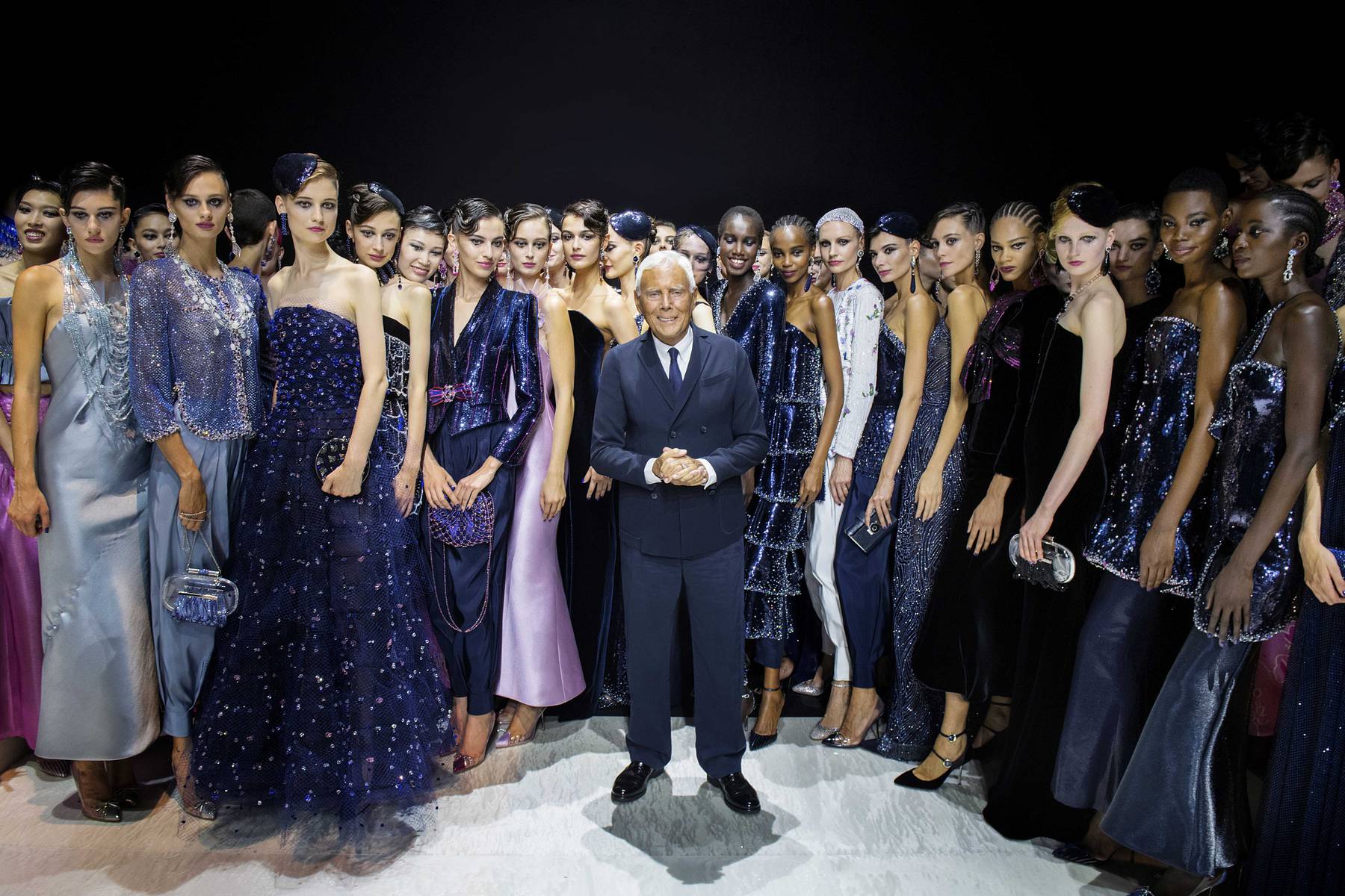 Giorgio Armani poses with models at the end of the runway show for his Privé couture line.