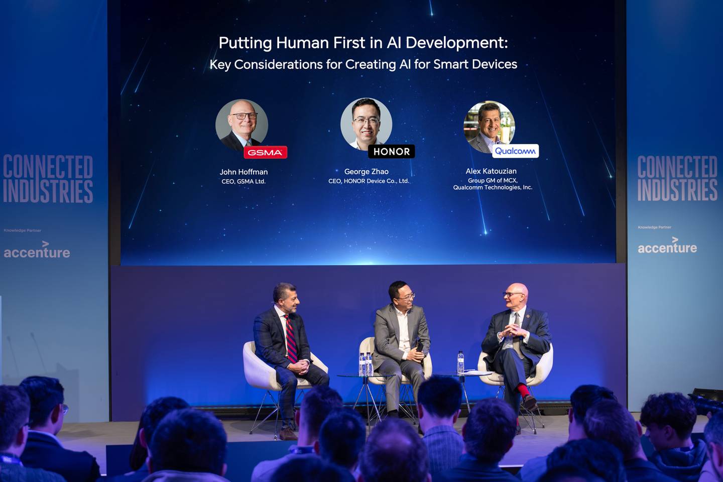 Panel discussion at MWC 2024 on ‘Putting Humans First in AI Development: Key Considerations for Creating AI for Smart Devices’. Panellists on stage from left to right: Qualcomm's Alex Katouzian, Honor's George Zhao and GSMA's John Hoffman.