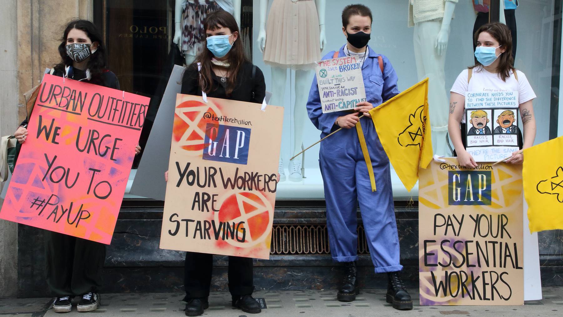 Activists hold placards during a demonstration in London's Regent Street Gap Urban Outfitters