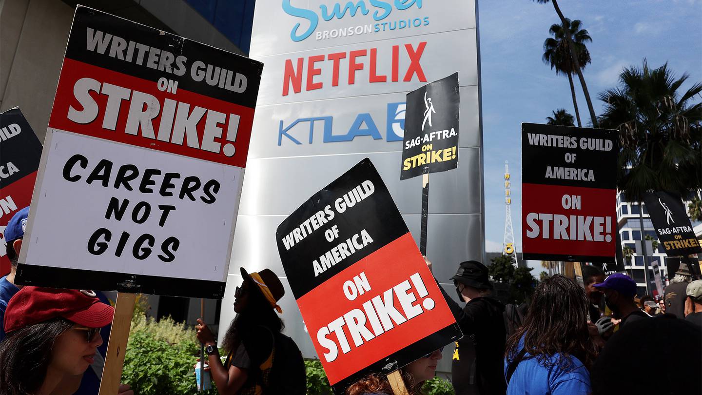 Striking Writers Guild of America members picket with striking SAG-AFTRA members outside Netflix studios.