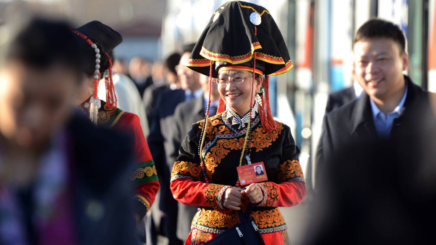 A delegate wears an ethnic minority costume as she arrives for the opening session of the 12th National People's Congress at the Great Hall of the People in Beijing.