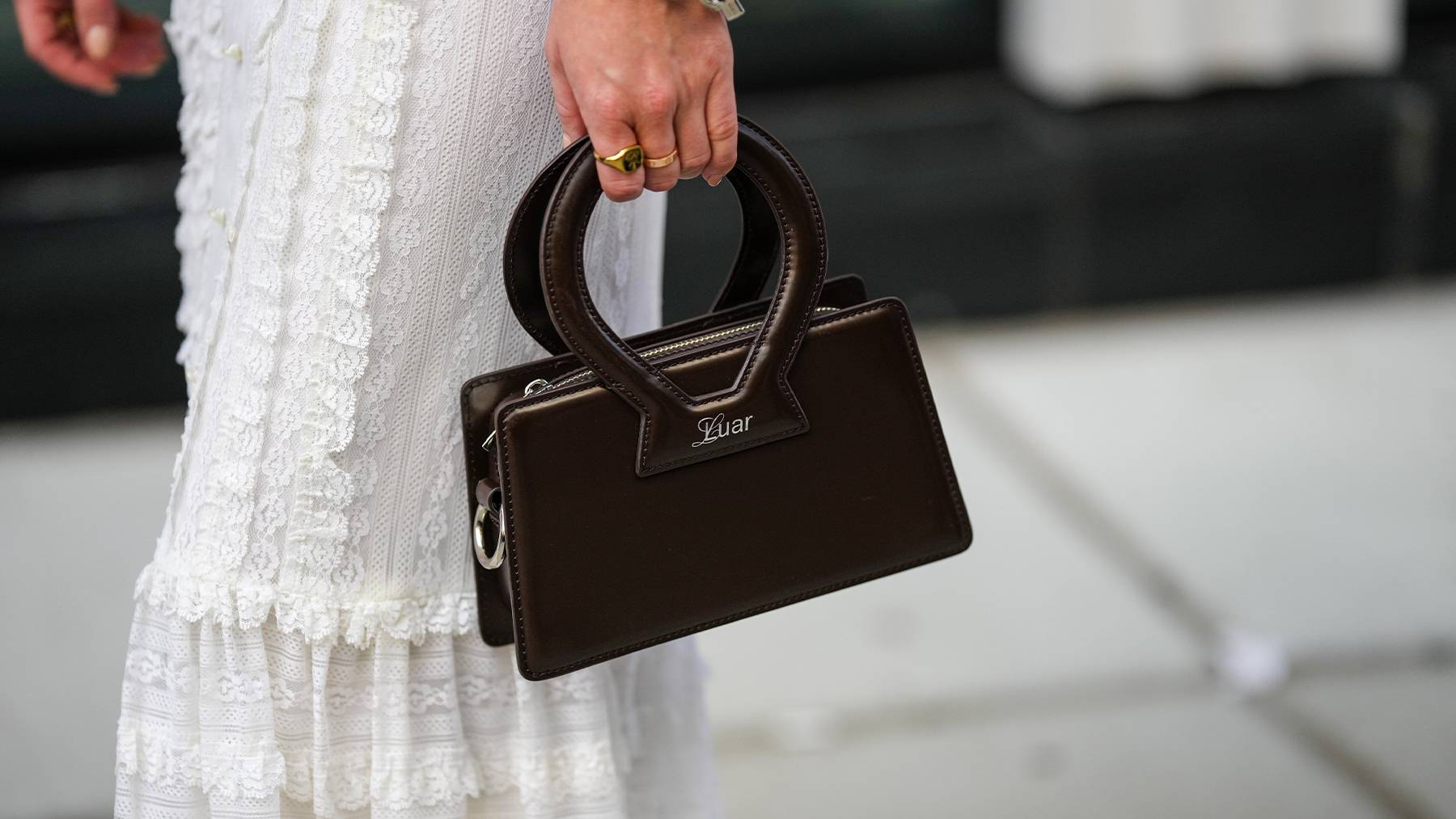 A dark brown Luar handbag.