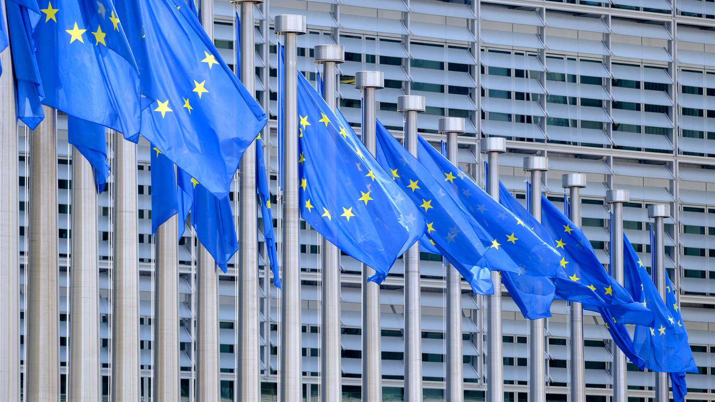 EU flags flutter in the wind in front of the Berlaymont, the EU Commission headquarters.