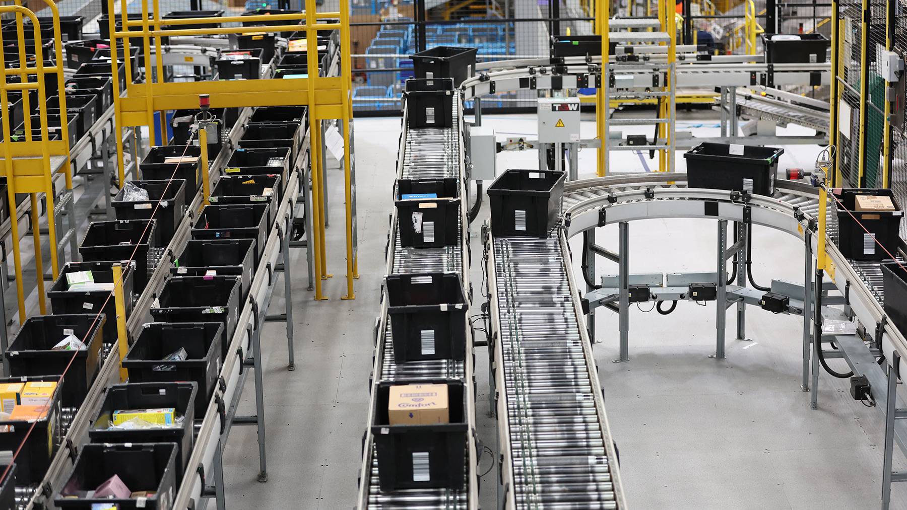 Products move down a conveyor belt in a large fulfillment centre.