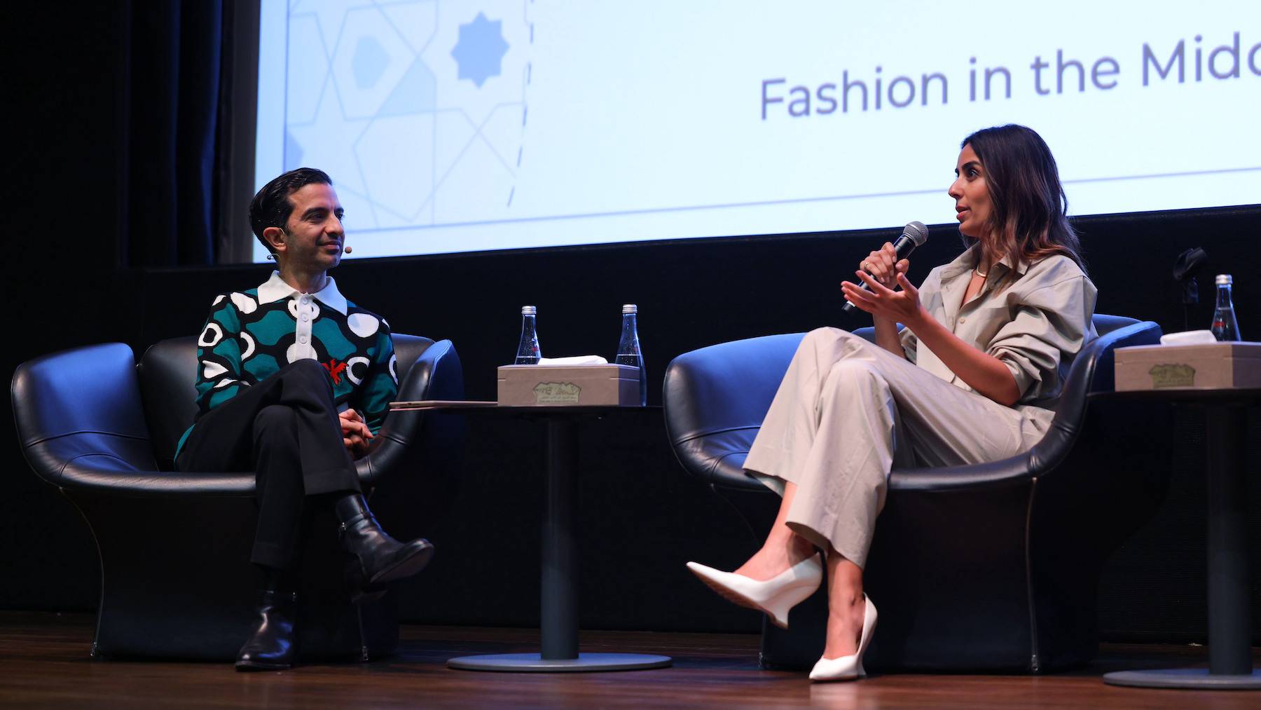 BoF's Imran Amed and Aubade Jewelry's Duha Al Ramadhan sit on stage at Oud Fashion Talks.