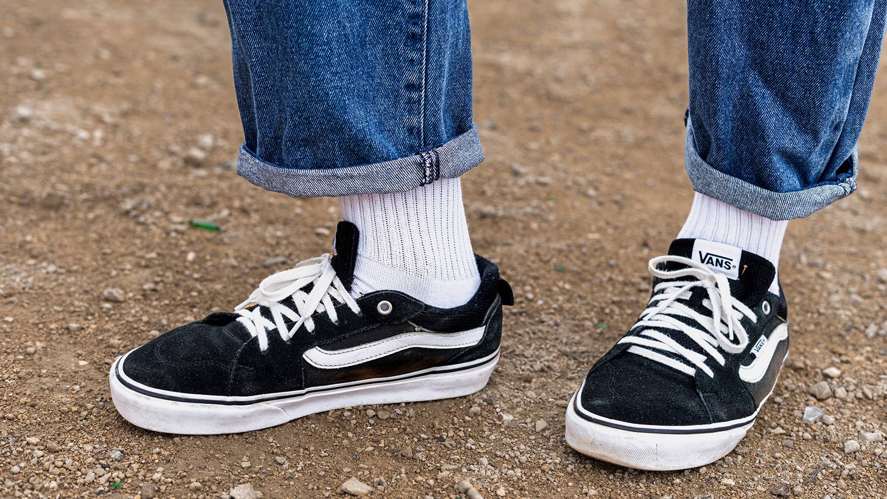 Vans Old Skool shoes with white tube socks and jeans.