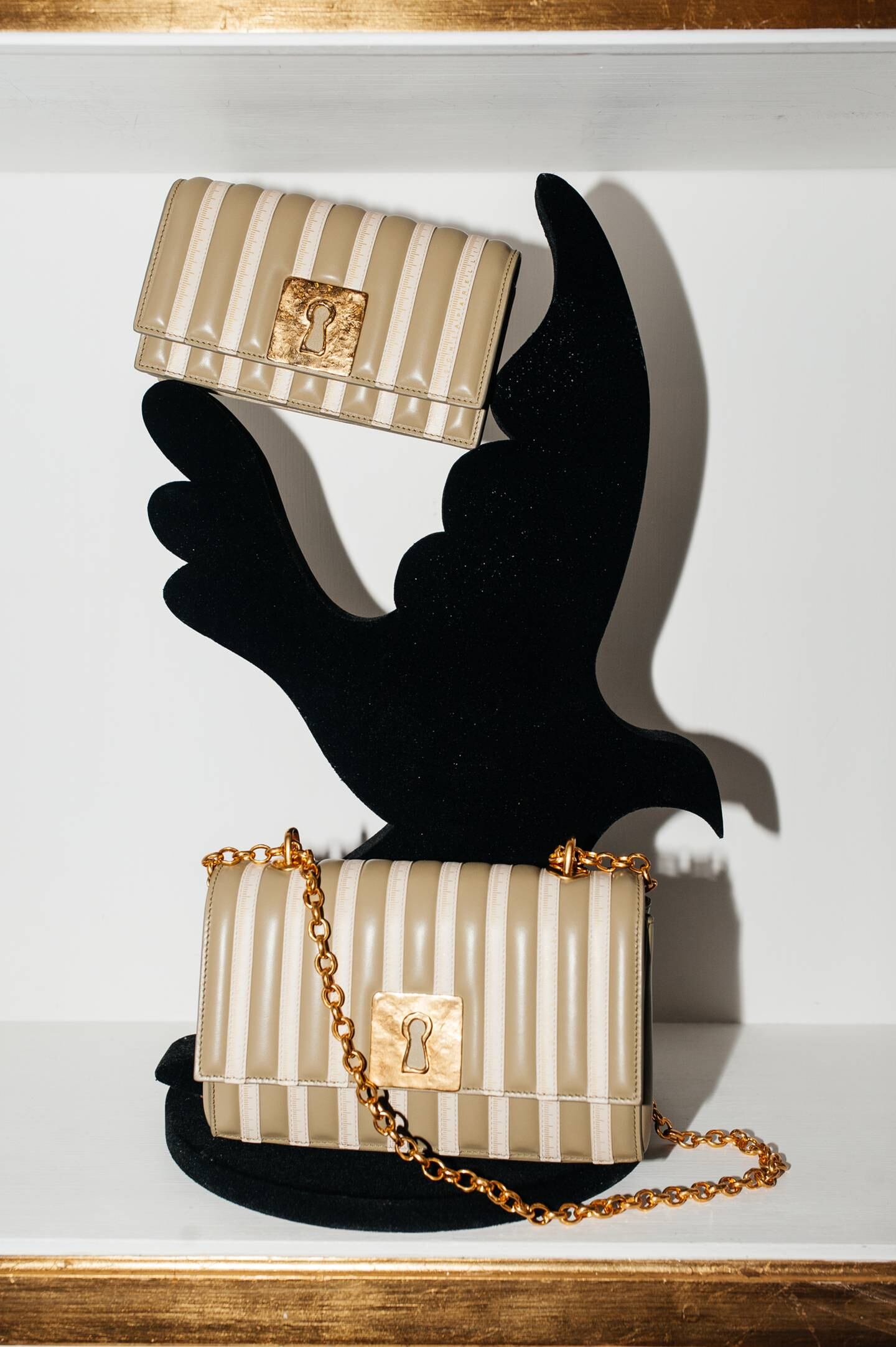 Keyholes and roughly cast bronze are key codes of Schiaparelli's revival, as seen on the brand's new "Schlap" bag.