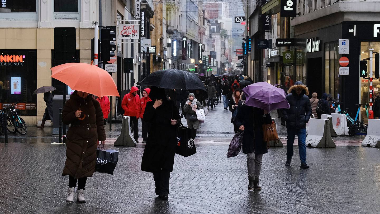 Shoppers on a rainy street.