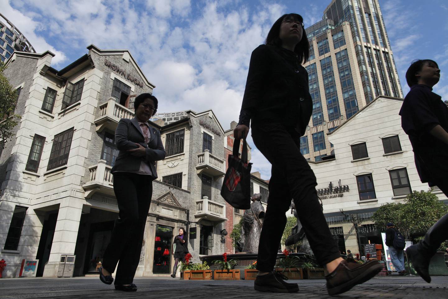 Visitors and shoppers walk through Shui On Group's in Shanghai, China. Getty Images.