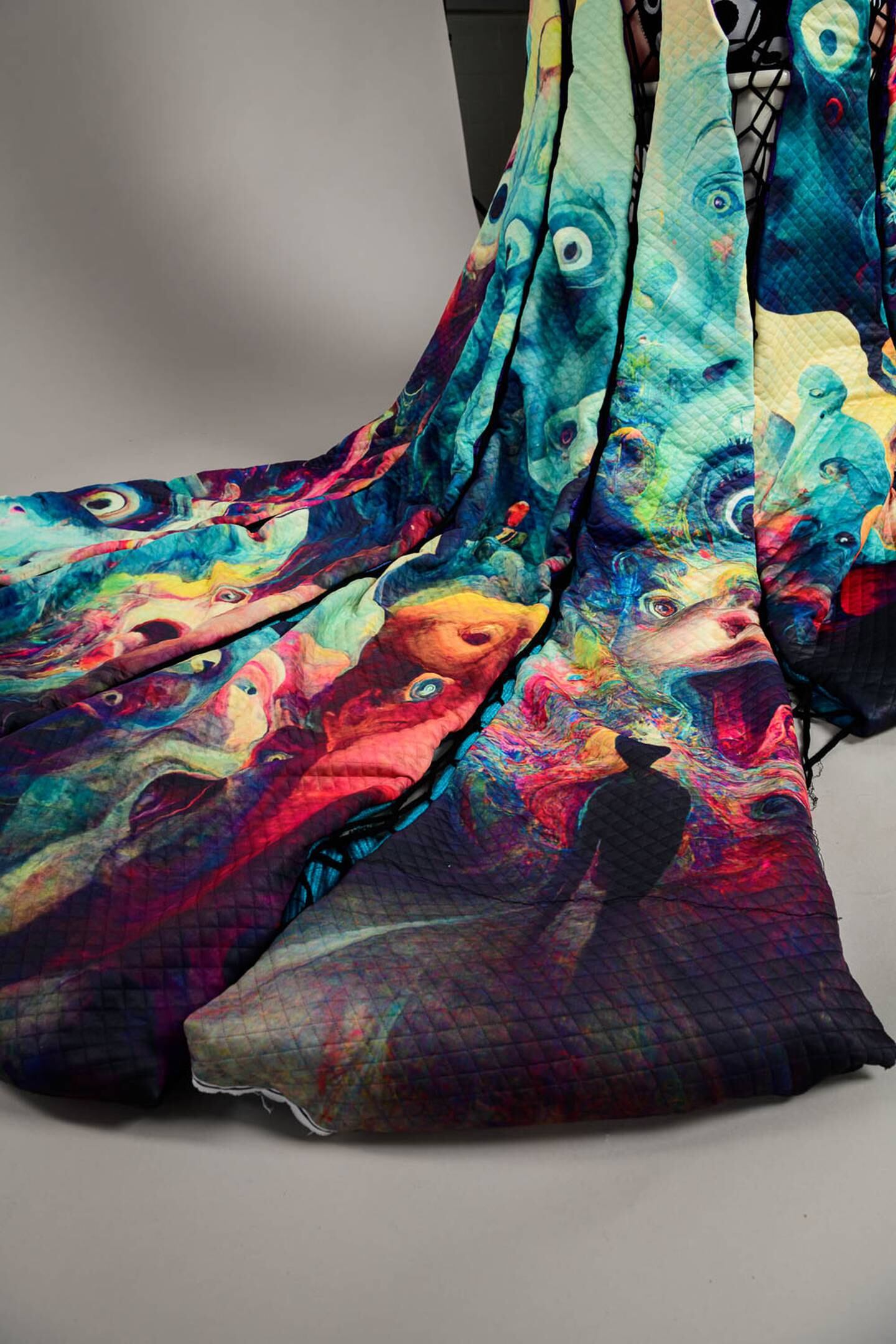 A colourful, psychedelic skirt with imagery such as eyes, the silhouette of a figure walking and animal-like creatures.