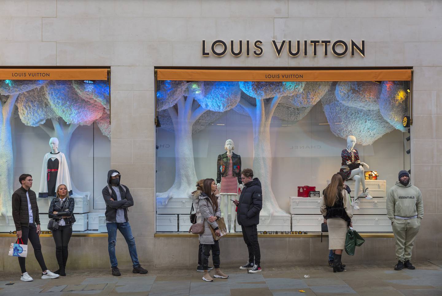 Masked shoppers queuing outside the Louis Vuitton store In London's Bond Street. Getty Images.