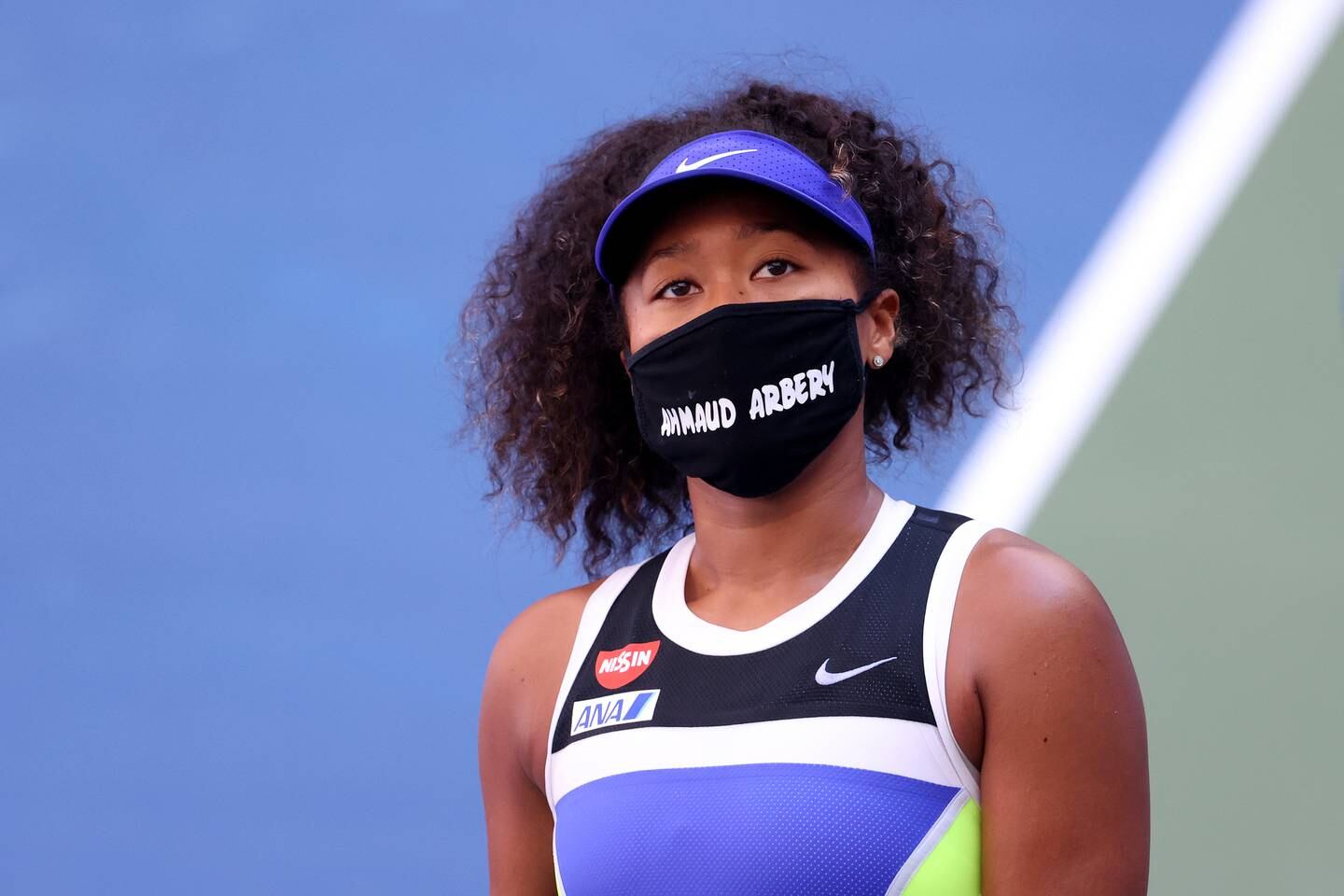Naomi Osaka wears a protective face mask with the name of Ahmaud Arbery — a Black man fatally shot by a group of white men while jogging  —  at the 2020 US Open.