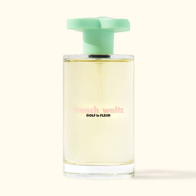 An image of Golf le Fleur's French Waltz fragrance bottle with green floral cap.