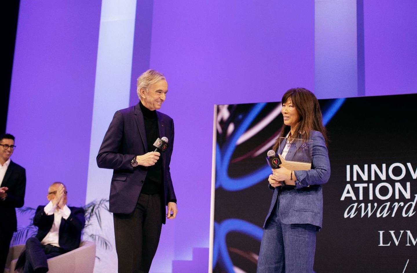 Sojin Lee, founder of the last mile delivery service Toshi, receives an award from LVMH chairman Bernard Arnault in Paris.
