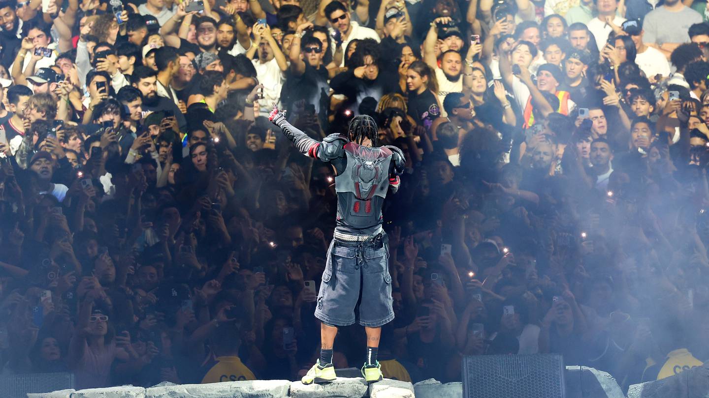 Travis Scott performs in front of fans Inglewood during his ongoing Utopia tour, which reportedly generated over $1 million in merch sales on multiple nights.