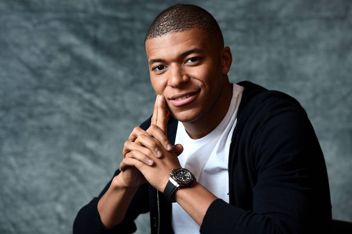 France's forward Kylian MBappe poses during a photo session after an interview with AFP in which he announced the formalization of his Ambassadorship with the Swiss luxury watchmaker Hublot.
