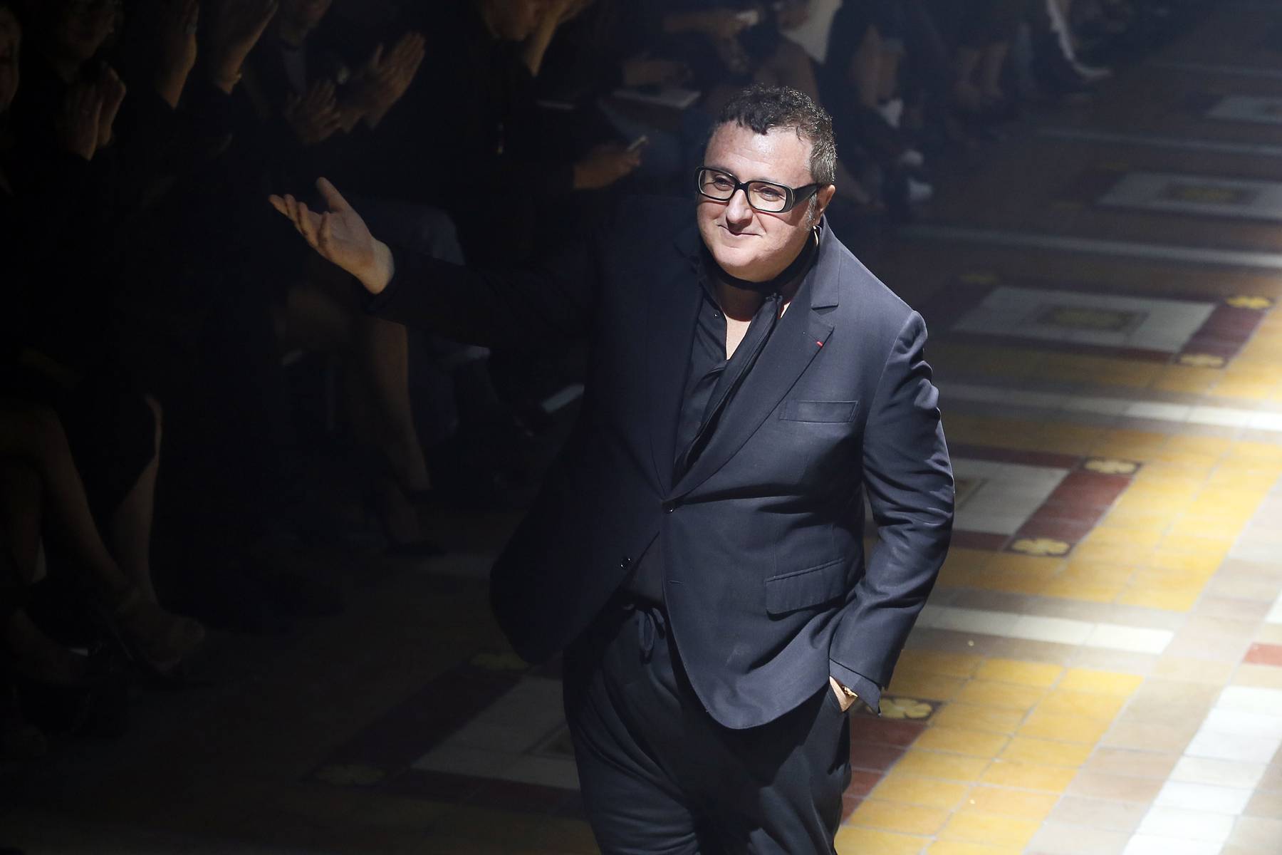Alber Elbaz acknowledges the audience at the end of the Lanvin 2015 Spring/Summer ready-to-wear collection fashion show. Patrick Kovarik/AFP via Getty Images.
