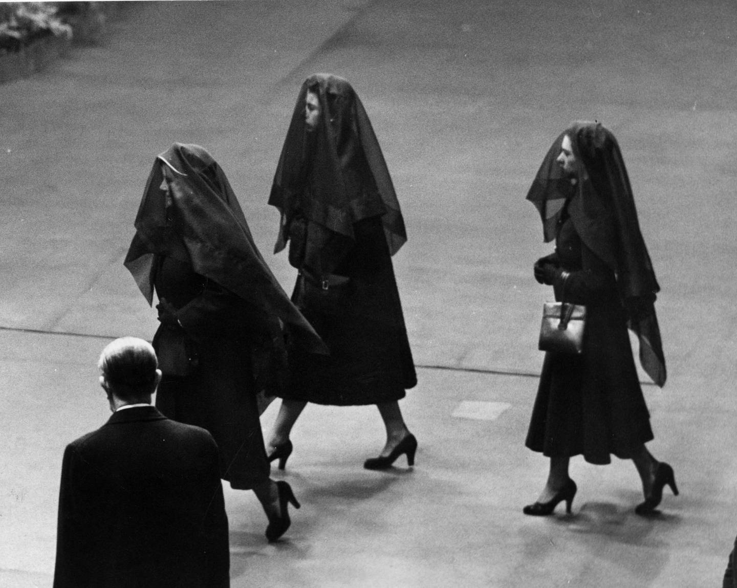 Queen Elizabeth II, the Queen Mother and Princess Margaret wear veils at the funeral of King George VI.