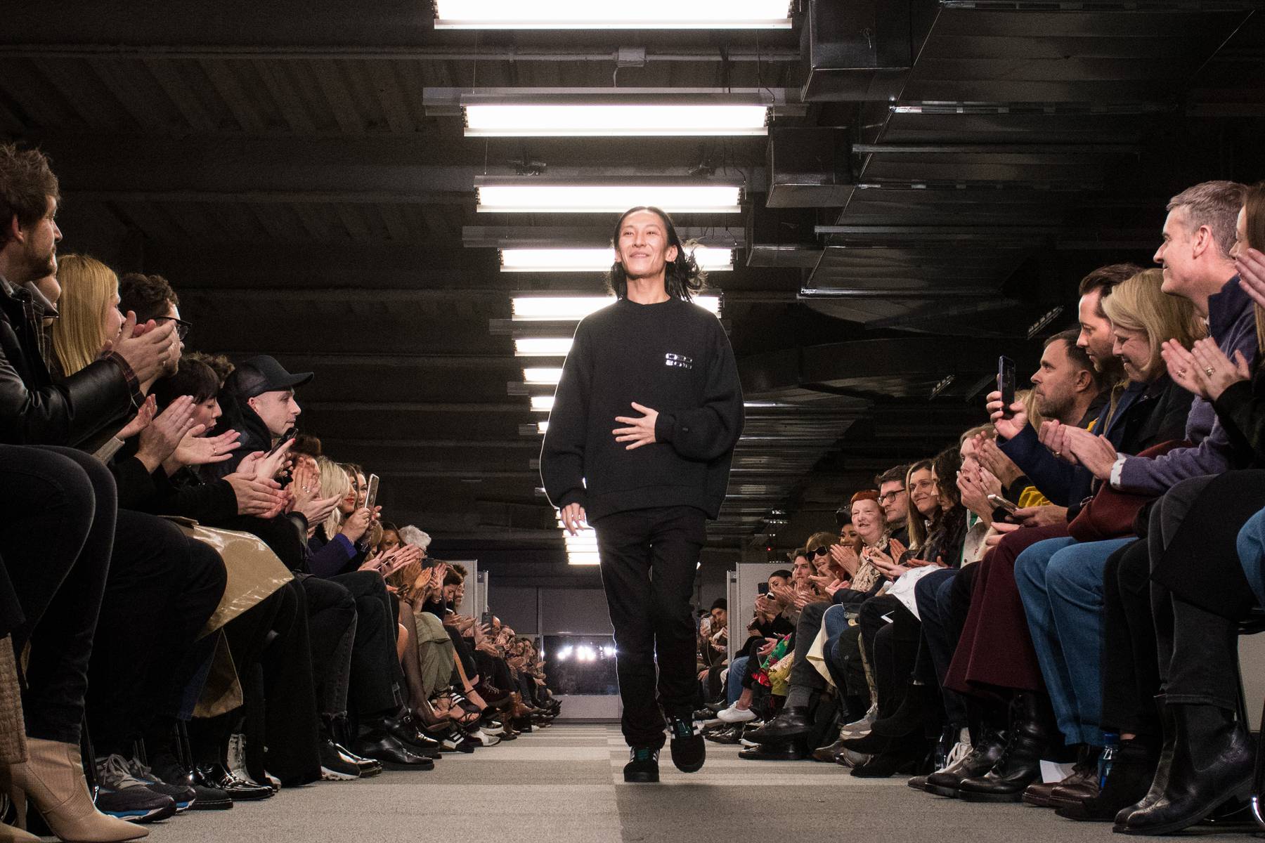 Alexander Wang takes a bow at his February 2018 runway show. Getty Images.