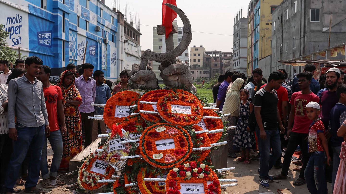 A monument for victims of the Rana Plaza building collapse is covered with floral wreath as people mark the sixth anniversary of the disaster at the site where the building once stood in Savar, on the outskirts of Dhaka, on April 24, 2019