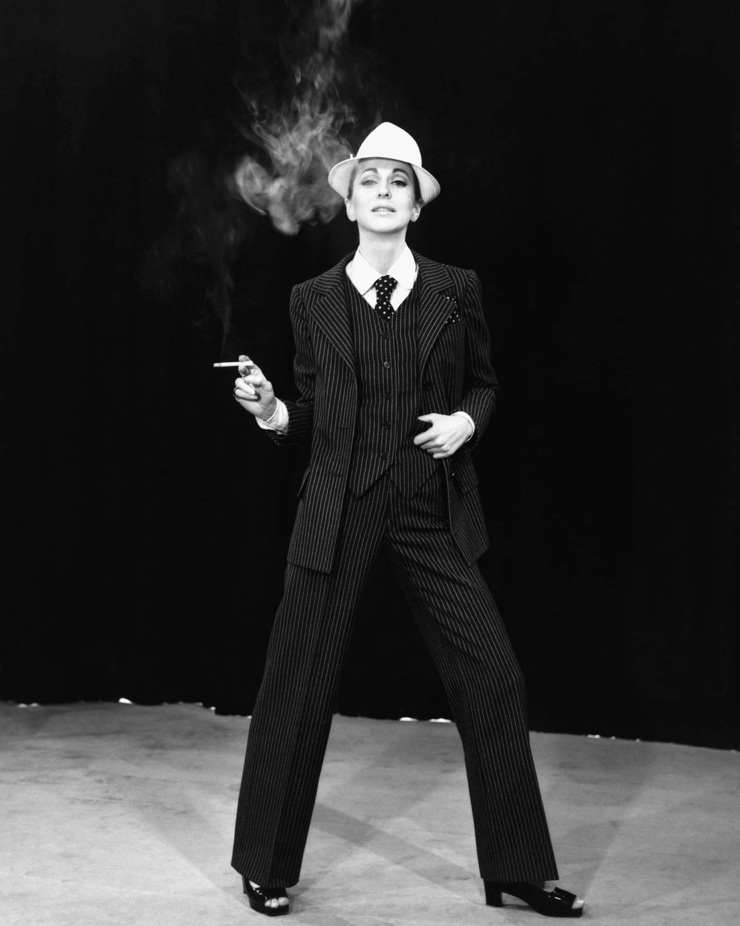 A model wears a three-piece suit designed by Yves Saint Laurent. France, 1967.