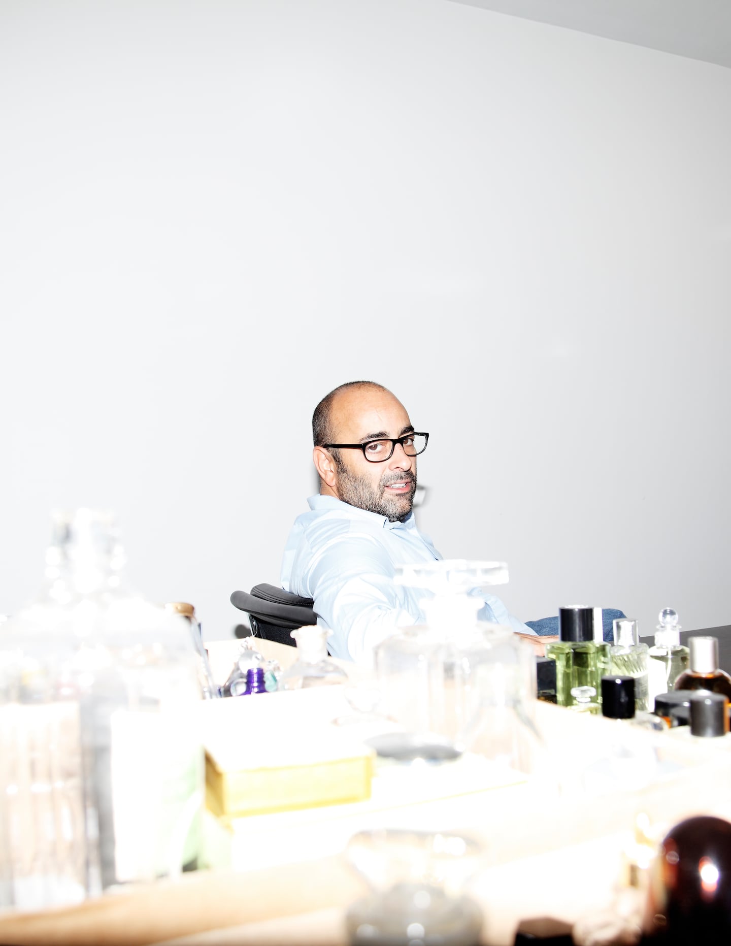 Fashion art director Ezra Petronio sitting at a desk.