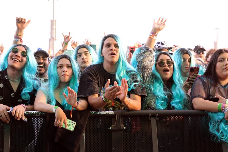 Festival goers wear Karol G-style wigs at the 2022 Coachella in April 2022 in California.