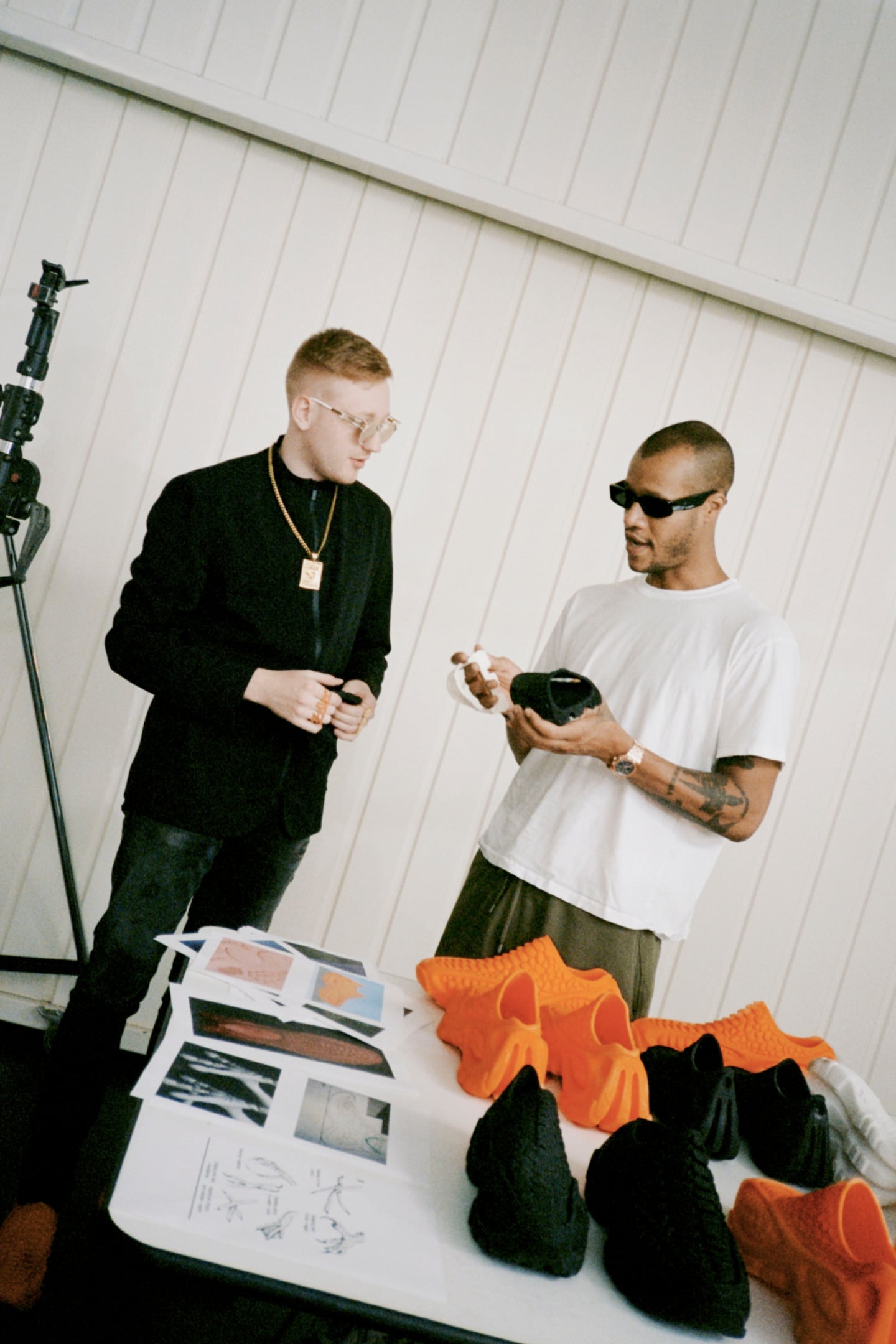 Cornelius Schmitt and Heron Preston stand in front of a table of 3D-printed shoes.