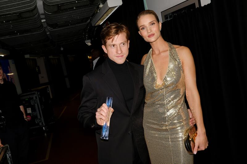 Daniel Lee poses with Rosie Huntington-Whiteley backstage after accepting the Accessories Designer of the Year award on behalf of Bottega Veneta during The Fashion Awards 2019 held at Royal Albert Hall in 2019 in London