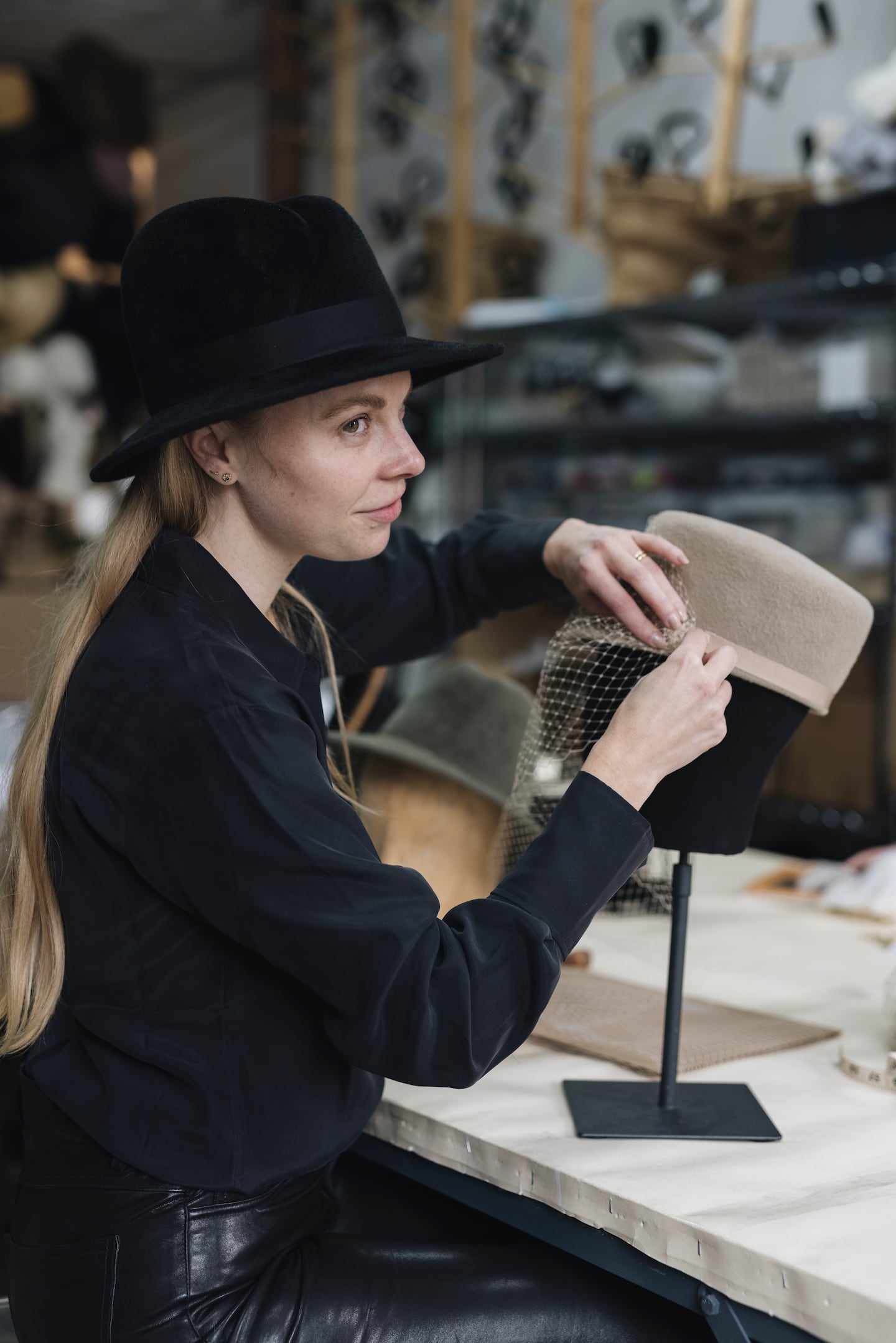 Accessories designer and milliner Gigi Burris O'Hara, who is launching Closely Crafted, making a hat.