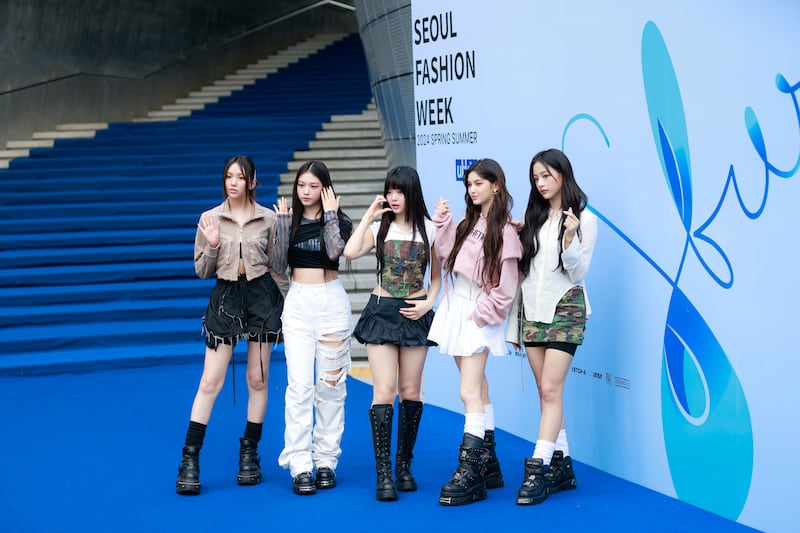 NewJeans members pose outside the S/S 24 season show for Ulkin during Seoul Fashion Week in September 2023 in Seoul, South Korea.