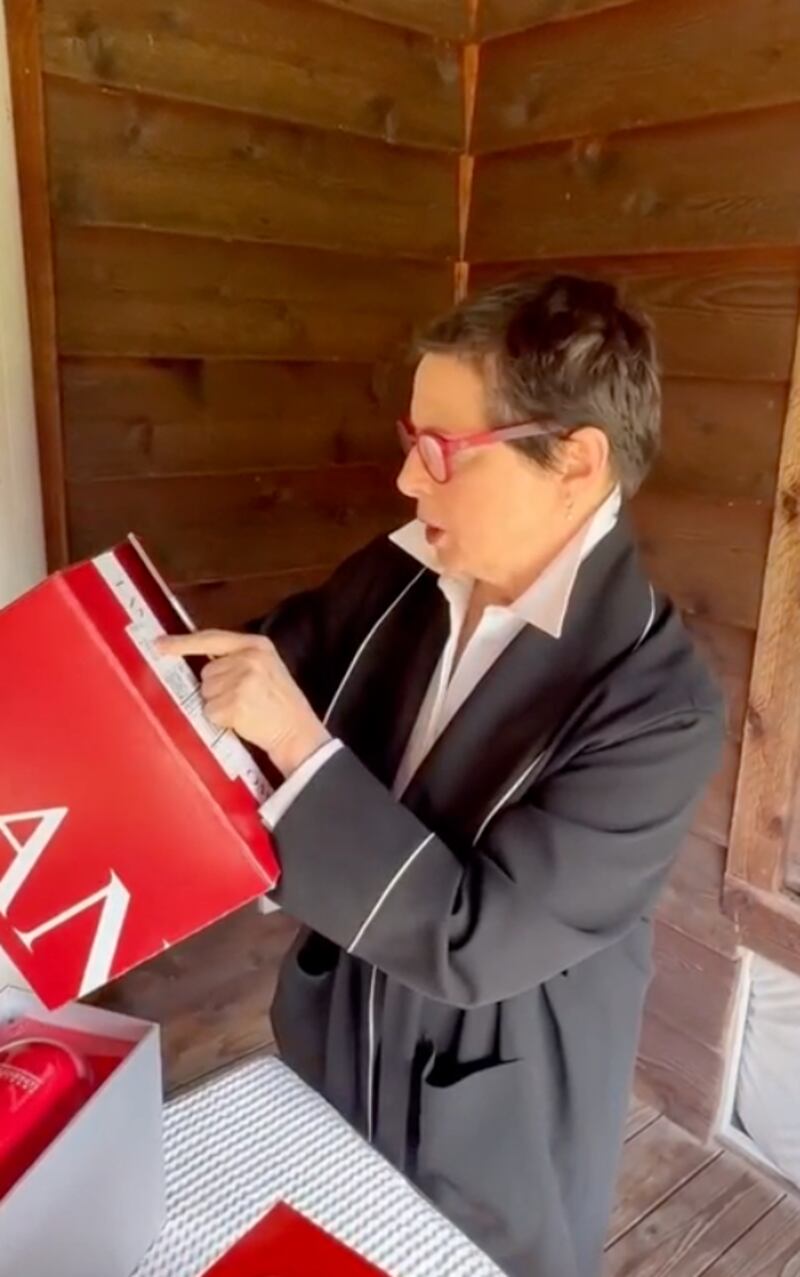Isabella Rossellini opens her PR package.