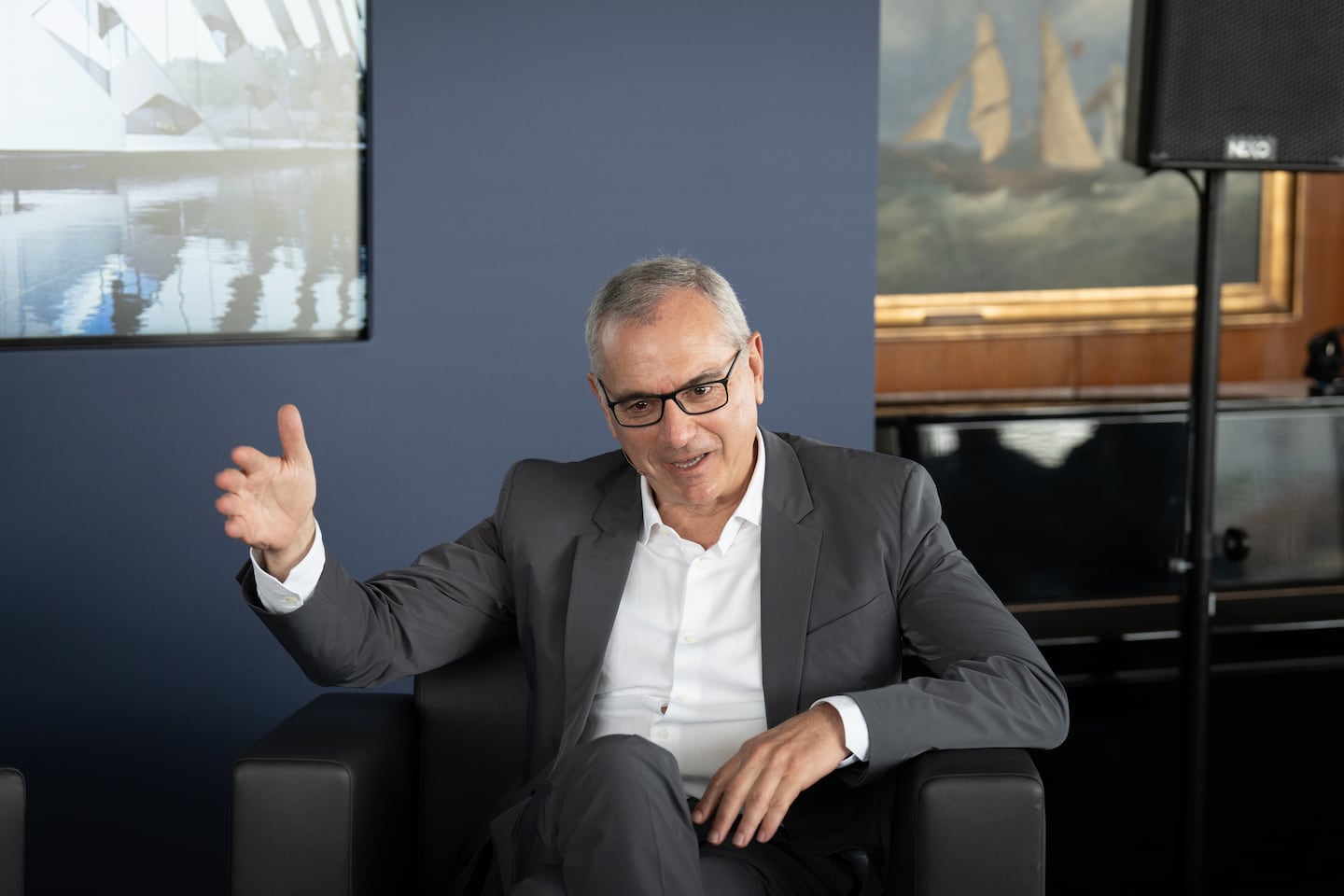 An image of Puig chairman and CEO Marc Puig in conversation.