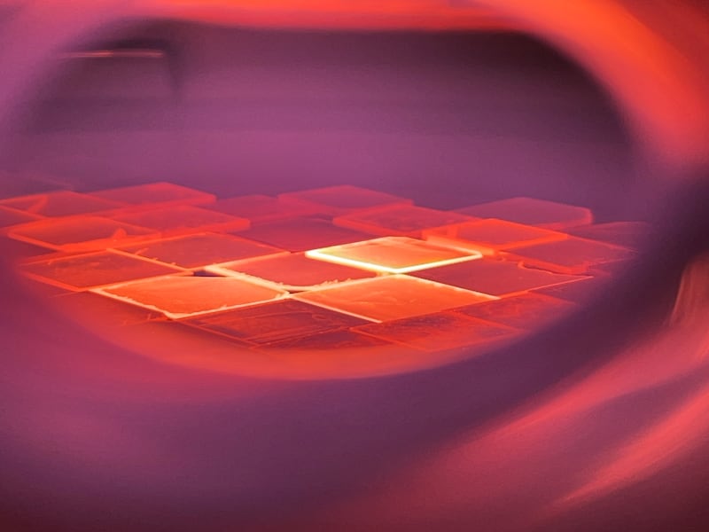 An array of square wafers sit inside a reactor, collecting carbon atoms that will eventually accumulate to form rough diamonds.