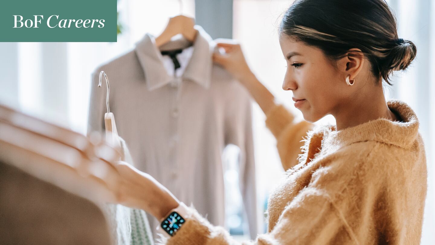 Retail employee looking at store merchandise.