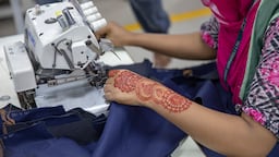 A garment worker sewing in a factory in Bangladesh.