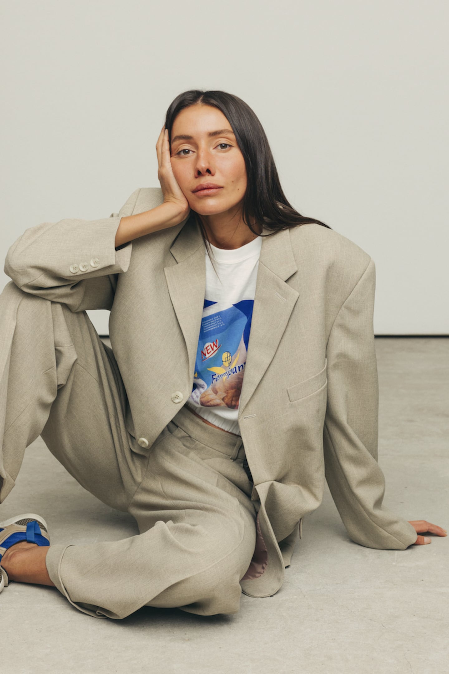 A portrait of Julie former Vogue Ukraine fashion director and Better founder Julie Pelipas in a loose fitting grey suit.