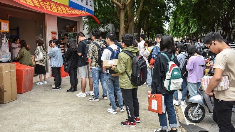 College students line up to pick up packages at the online shopping pick up point during China's online shopping festival. Getty Images.