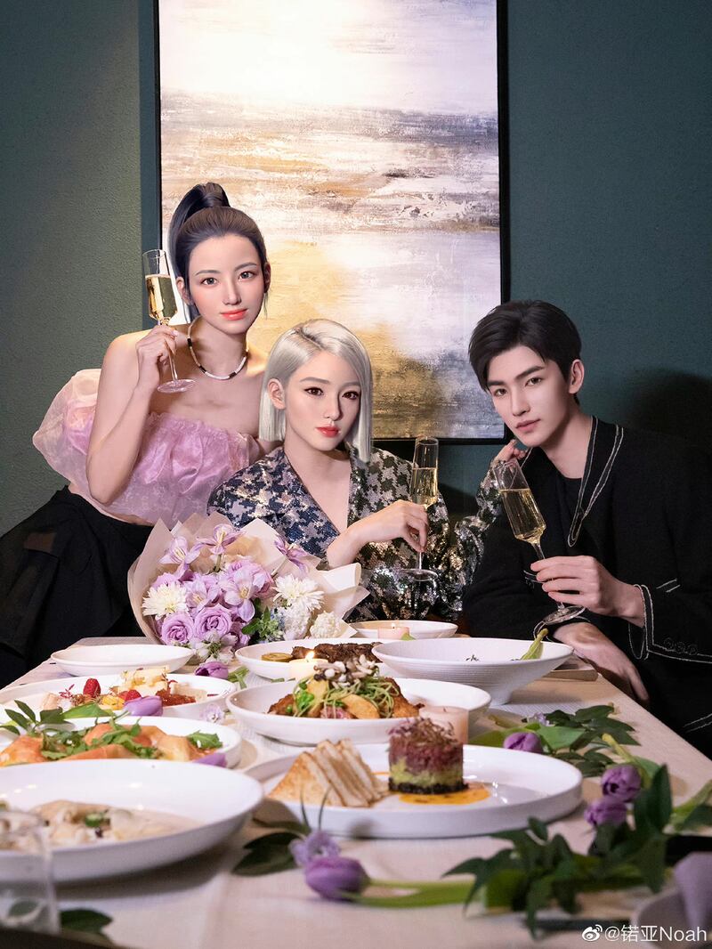 Virtual influencers, two women with blonde and brown hair and a man, sat at a dinner table holding champagne. They all wear occassionwear for the dinner party.