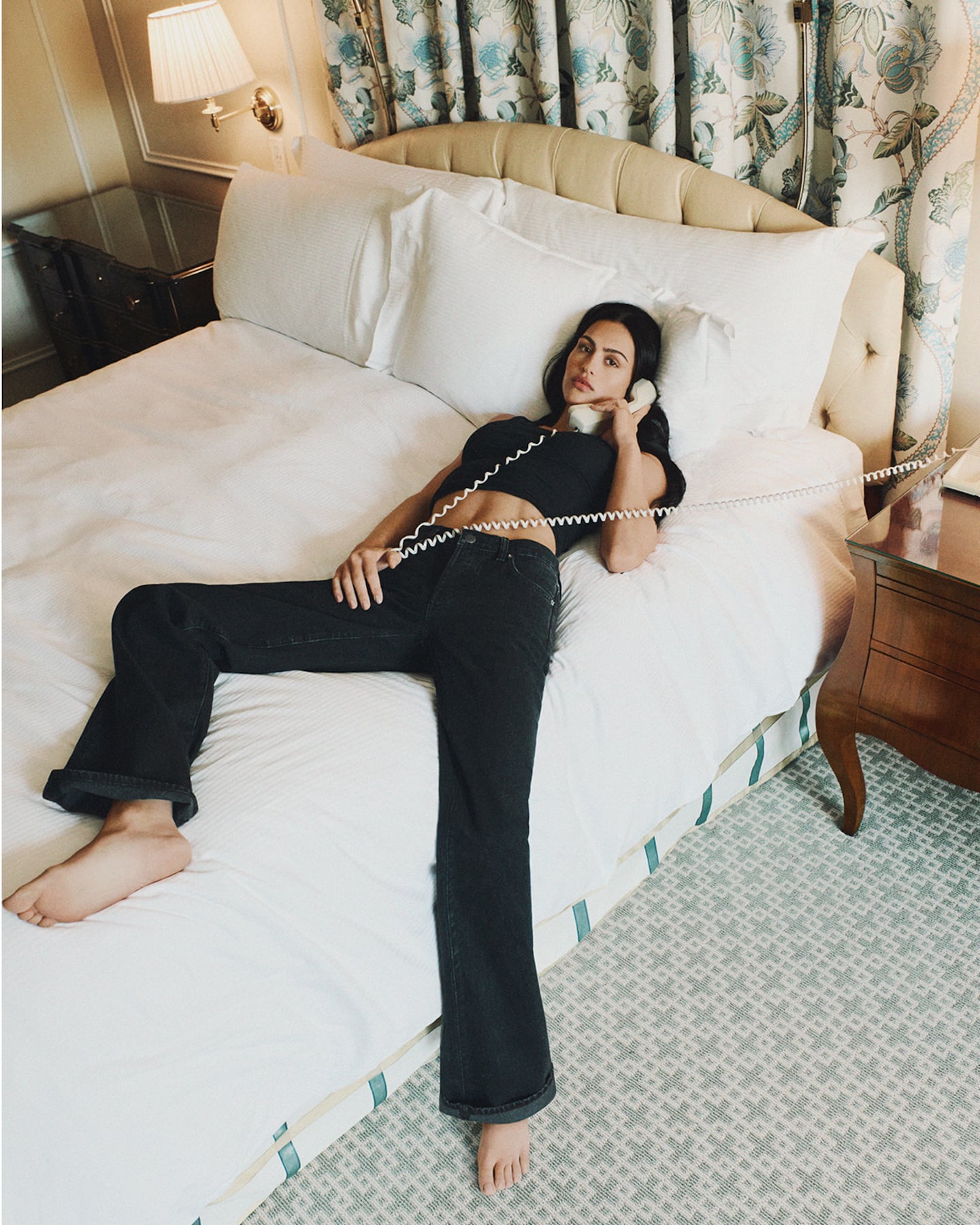Frame is on track to generate $300 million in sales this year after steering clear of a public scandal involving one of its founders. Model on bed.