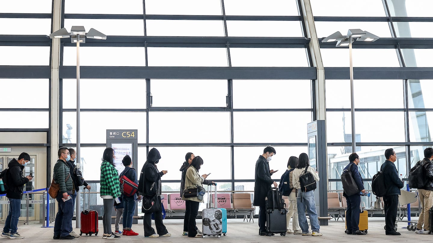 Passengers at Pudong International Airport in Shanghai.