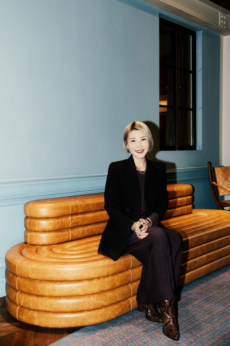 Janet Wang wearing a black trouser suit.
