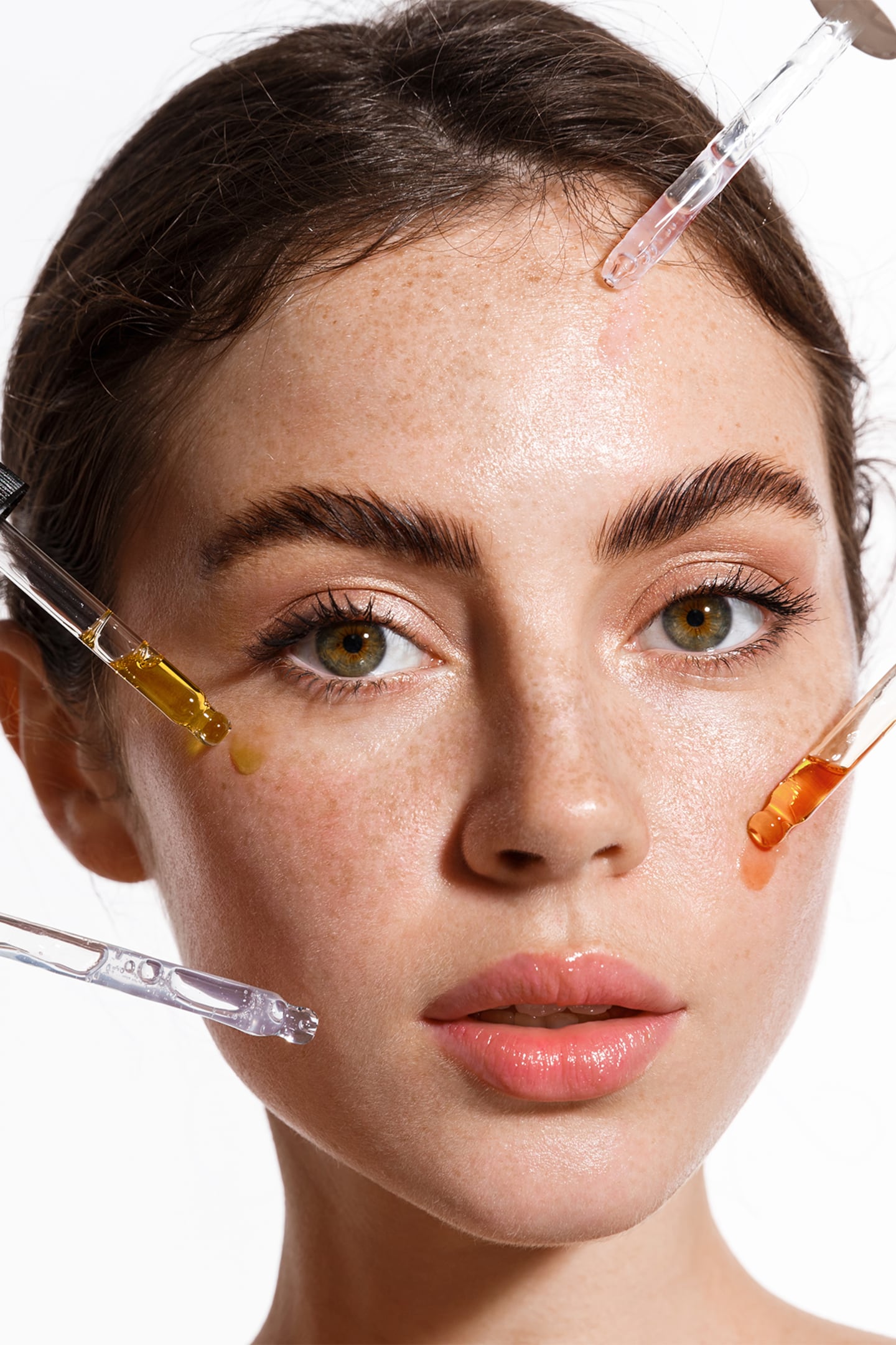 A young woman with serums on her face.